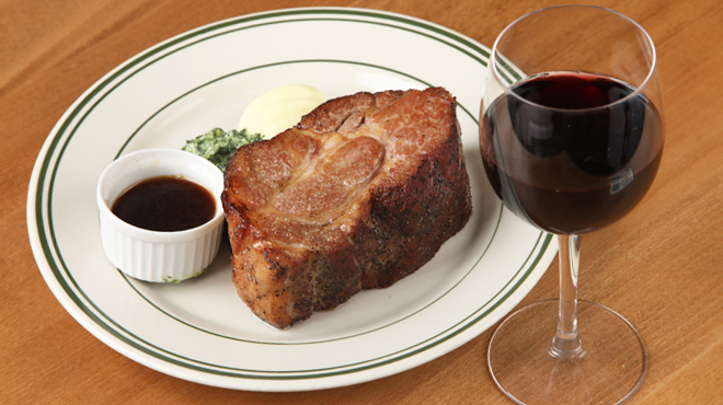 マロリーポークステーキ - 料理写真:ポークステーキ、ワインを並べた写真