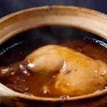 Soft chicken rice with sauce in clay pot