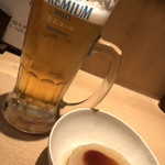 Ochobo Gushi - ビールとお通しの大根。田楽味噌がほっこり合います。