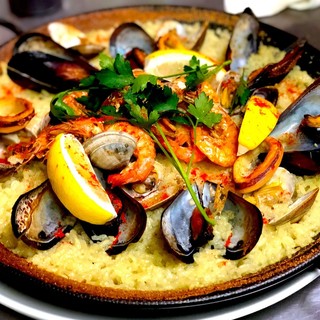 Mediterranean paella with plenty of seafood is baked in an oven from raw rice!