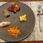 アビタコロ - モダンな大理石プレートの上に、センス良く盛り付けられた前菜の盛り合わせ