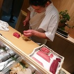 鮨西光 - 鮪を切りつける店主・西巻さん