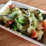 Oven-baked vegetables and chicken topped with cheese