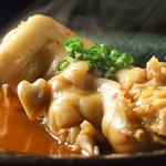 旬の鮮魚と魂の煮込み 照 - 豚足のピリ辛トロトロ煮込み