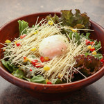 Crispy Caesar salad topped with warm egg