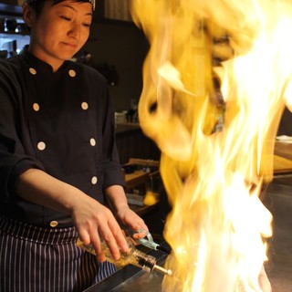 Impressive flambé performance! A female chef grills the finest Steak