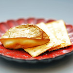 Grilled camembert cheese with straw