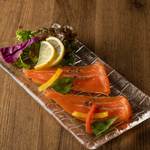 Smoked salmon carpaccio with olive dressing