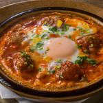 Tomato stew with kefta and dropped egg