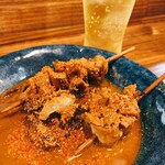 串焼き 巴 - もつ串煮込み  七味鬼がけ