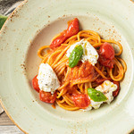 Spaghetti with burrata, cherry tomatoes and basil