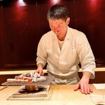 Takaoka - 炙り鰆寿司の磯辺巻き〜手間暇かけた鰆寿司を、仕上げに備長炭で焼き目を入れる丁寧さ。ご主人の真剣な眼差しが緊張感を漂わせる。