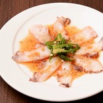 Octopus sashimi with sesame soy sauce and green chili pepper