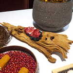 レスト ケイ ヤマウチ - 竹炭シフォン・生ハム。流木のような、有機的な形状の樹木に腰掛けて