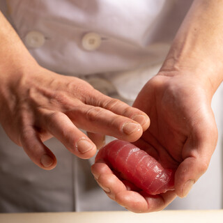 A craftsman holds it carefully.