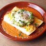 Braised beef tendon enchilada topped with guacamole and hot spring egg