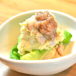 Potato salad with sausage for adults topped with Shuto