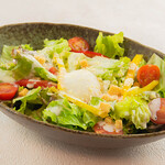 Caesar salad topped with plump warm eggs