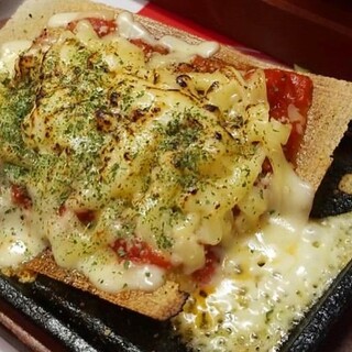 Cheese gyoza melting on a hot iron plate