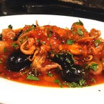 Octopus and olives stew in spicy tomatoes