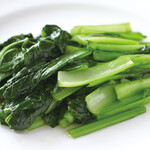 Stir-fried seasonal greens over high heat (salt, garlic)