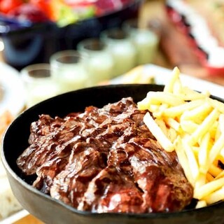 Serving freshly grilled Steak in an immersive open kitchen