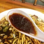 ラーメンの味楽 - 表面に脂たっぷりの黒いスープ。
      「富山ブラック」といっても、塩辛い辛口タイプではなく、まろやかさも感じるスープです。