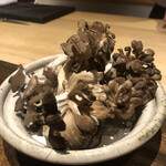 温石 - 天然の黒舞茸。土鍋で蒸し焼きに。汗が出たところで鰹出汁を投入、その旨味を煮含ませます。数滴の醤油で味を整え、休ませれば完成。実は白甘の脂拭き用に、鰹のイノシン酸と乳化した汗は、締めのご飯に軽くかけて