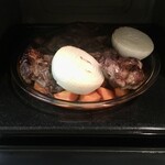 紀ノ国屋 - 北海道産和牛の脛肉は、二日間マリネしてからフライパンで表面だけを焼いた後、オーブンで香味野菜と一緒に焼く。