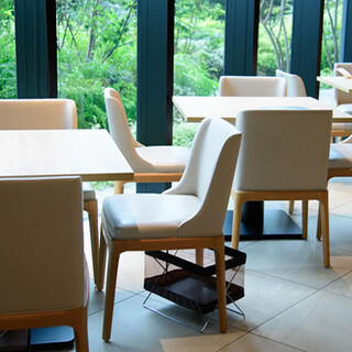 A variety of seats in an open space with nature in front of you