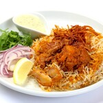 Johnny's Biryani - こちらのチキンビリヤニはビリヤニの聖地ハイデラバードで伝統的なレシピを採用したものです。
                      カレーを作ってからさらにお米を重ねて炊くのが通常のビリヤニの作り方ですが、このビリヤニはスパイスやハーブとともに鶏肉をヨーグルトでマリネしたものにお米を重ねて炊きます。その結果、お肉は柔らかく、旨味もお肉に残ったままなのです。
                      ジョニー自慢のチキンビリヤニと食べ比べてみてください！
                      