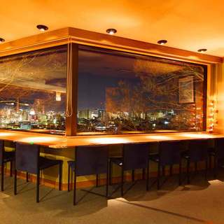 Counter seating with a view of the night skyline at our observation restaurant