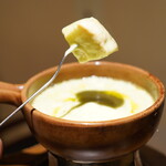 Cheese fondue with homemade baguette, seasonal vegetables and sausage