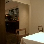 ラ ターブル ド クラージュ - 奥の個室から、カウンターとオープンキッチンを撮影。白と茶色、、、落ち着いた感じの店内です。