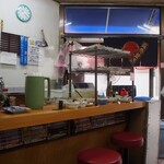 かね又 - 店内（入口横におかずが並んでいる）