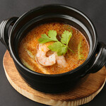 Kyoto style tom yum kung with yuzu flavor and mitsuba top