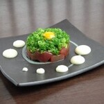 Tuna yukke covered in green onions