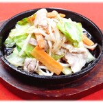 Stir-fried pork and vegetables on iron plate