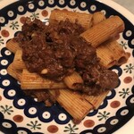 Pasta with beef, pine nuts and raisins in ragu sauce