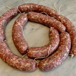 Grilled homemade sausage (salsiccia) with plenty of herbs