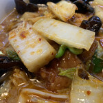 らーめん処 がんこ屋 - ピリ辛の中華風に炒めた白菜、ピーマン、キクラゲ、鶏肉などが乗ってます。