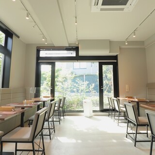 A bright and open store surrounded by greenery