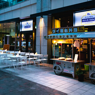 Open terrace seating with parasols during the day and LED candles at night.