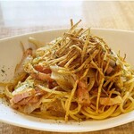 Japanese-style bacon and eggplant pasta topped with fried burdock