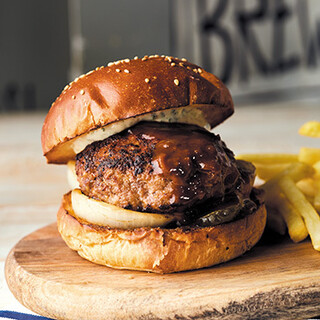 Focus on the buns. A hearty Hamburger with plenty of juicy meat!