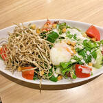 Caesar salad with soft-boiled eggs and fried noodles