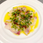 Today's fresh fish carpaccio with sun-dried tomatoes, capers, and yuzu pepper