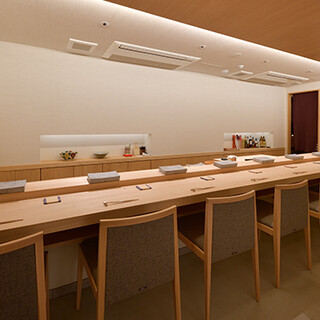 The well-lit lighting, jazz music, and elegant tableware create a perfect atmosphere for enjoying sushi.