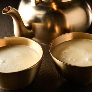 Raw makgeolli is served in a brass sake cup. Malt's "Master's Dream" too!