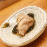 鮨おばな - 最初出てきた時、なんだか分かりませんでした。仙鳳趾産の真牡蠣です。軽く煮て冷まして鮟肝のような食感に変化。おさけの最強のツマミでした。薬味は生海苔の佃煮と柚子胡椒。絶品です。